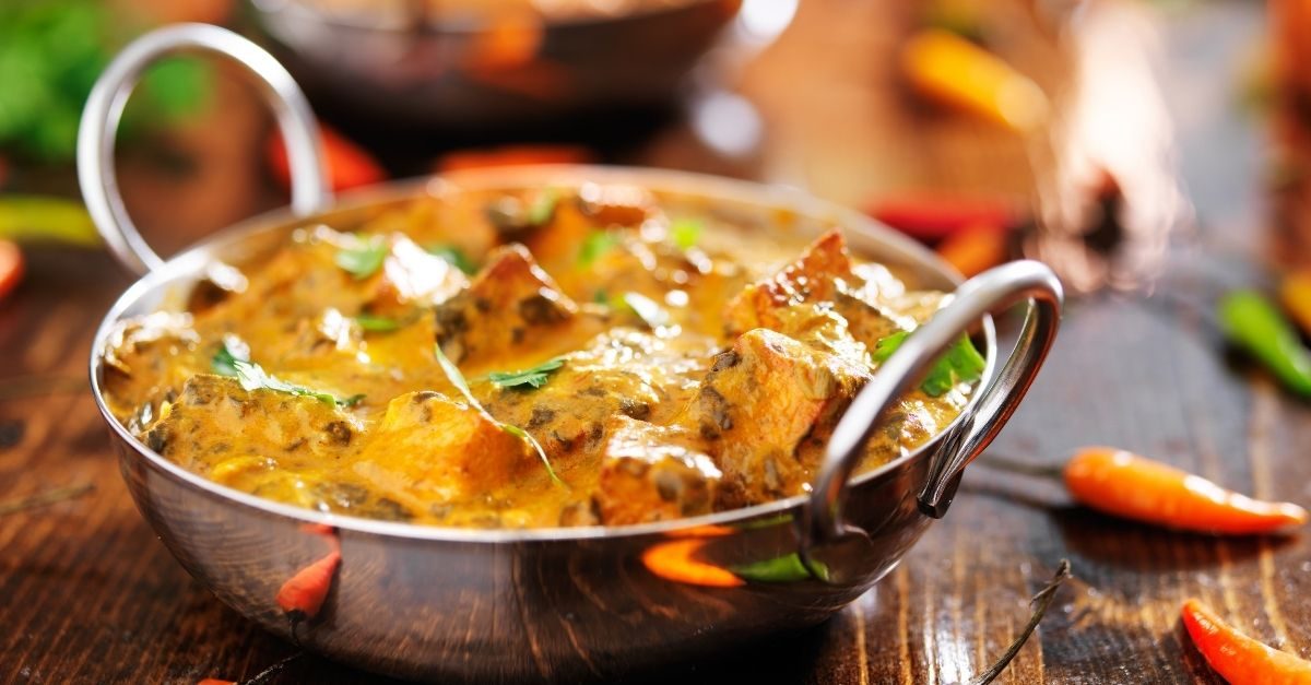 A curry served in a polished steel karahi