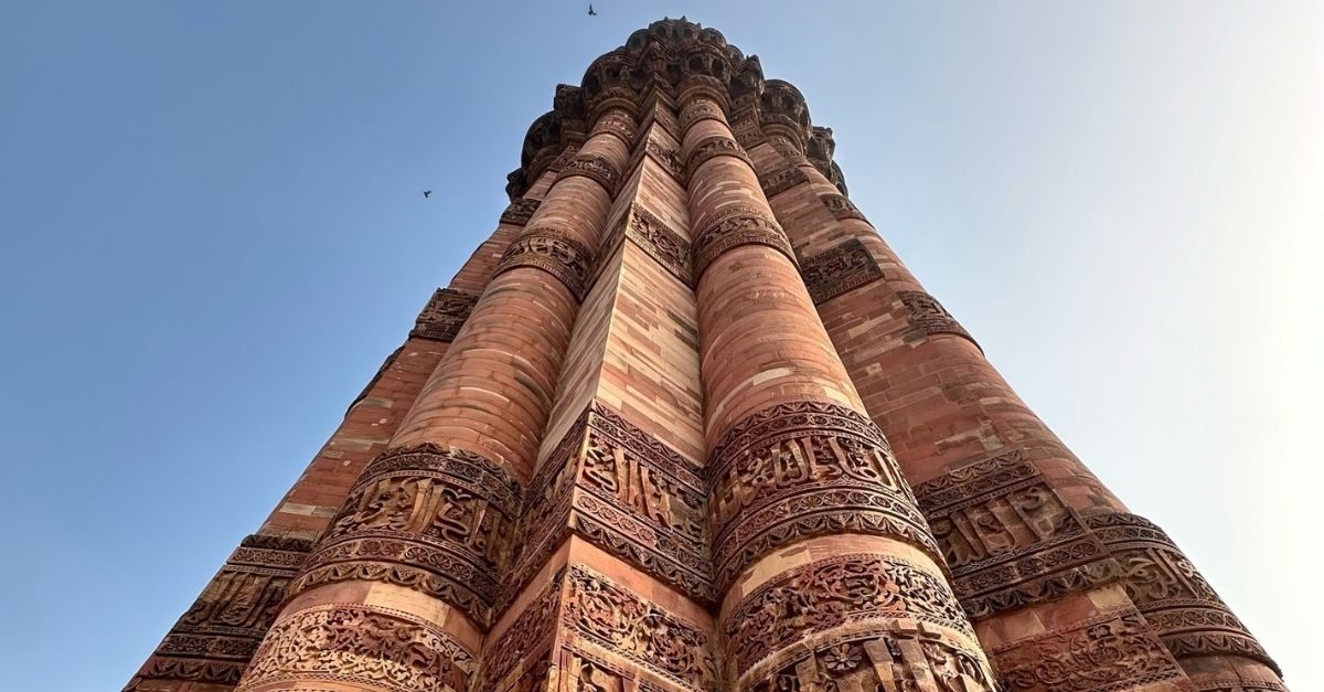 Looking up at the carved sandstone of the Qutub Minar in Delhi